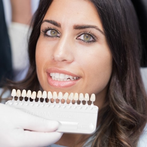 Woman being fitted for veneers by cosmetic dentist