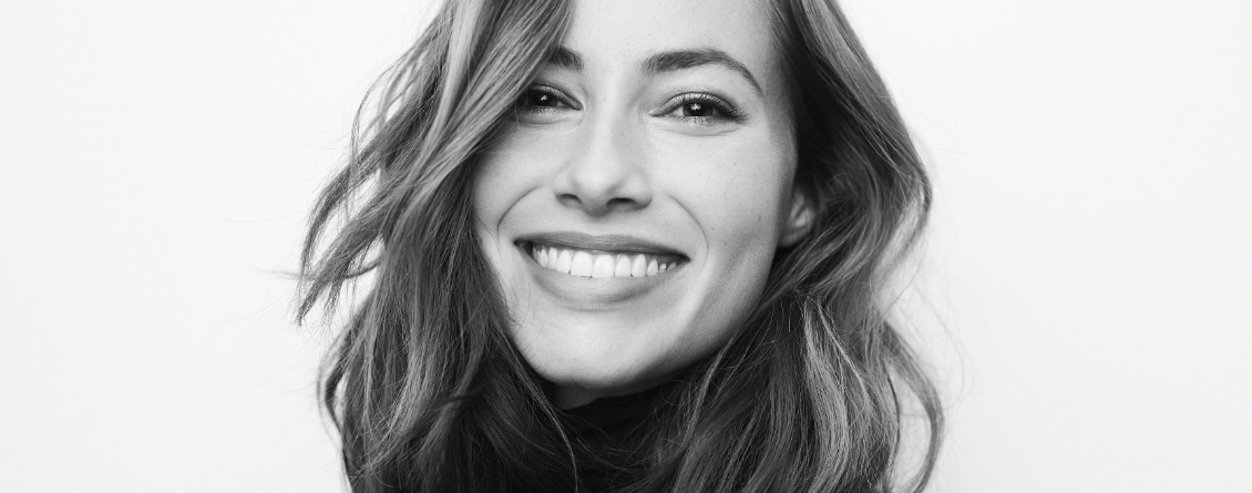 Woman with long wavy hair smiling