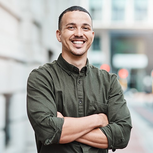 Man smiling after seeing Guardian dentist in Louisville