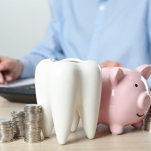 Coins next to a piggy bank