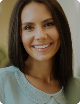 Woman with long dark hair smiling