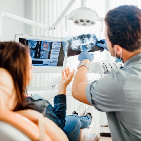 Dentist showing a patient X rays of their teeth